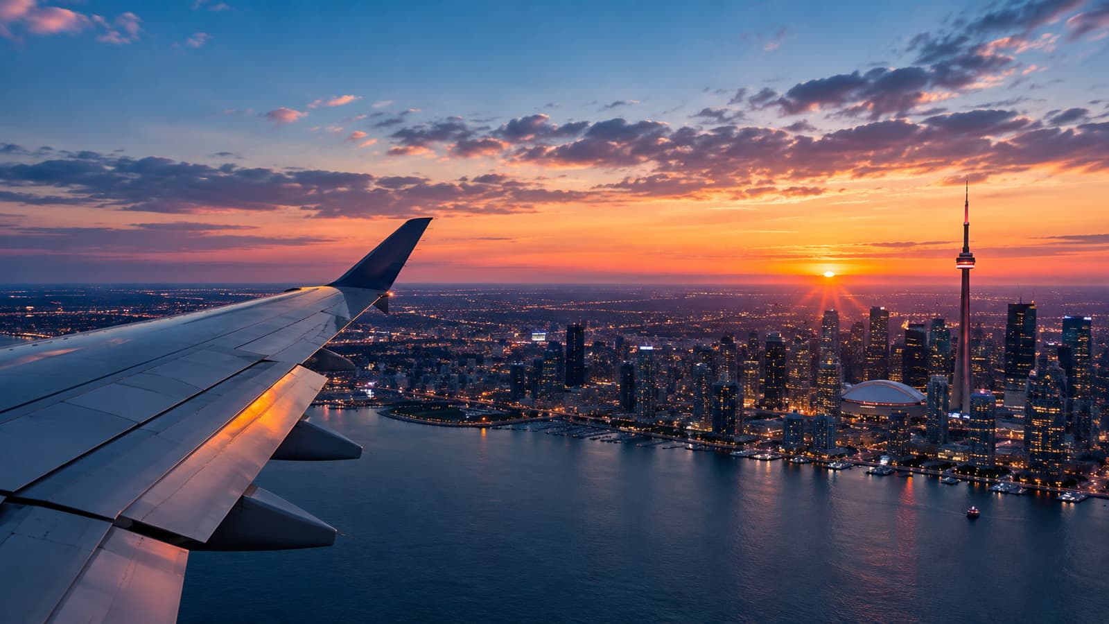 Illustration (AI-generated): an airliner’s wing over the Toronto skyline and the CN Tower at sunset.
